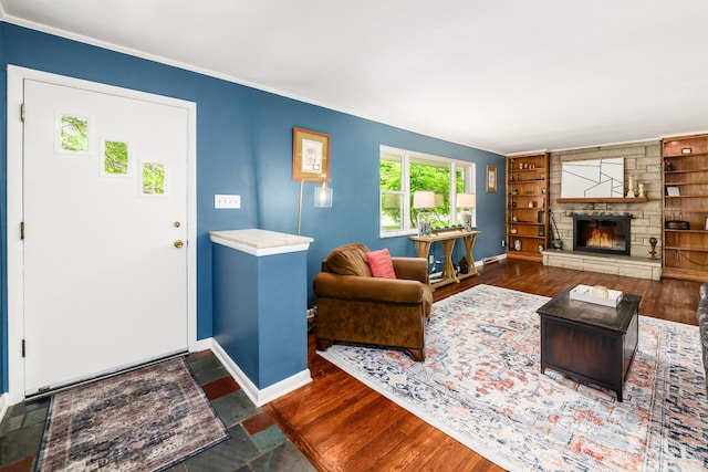 2175 Ridgeview Rd, Upper Arlington, OH 43221 - living room featuring baseboards, built in shelves, wood finished floors, a fireplace, and crown molding