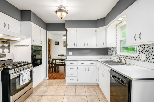 2175 Ridgeview Rd, Upper Arlington, OH 43221 - kitchen with black appliances, a sink, under cabinet range hood, light countertops, and tasteful backsplash