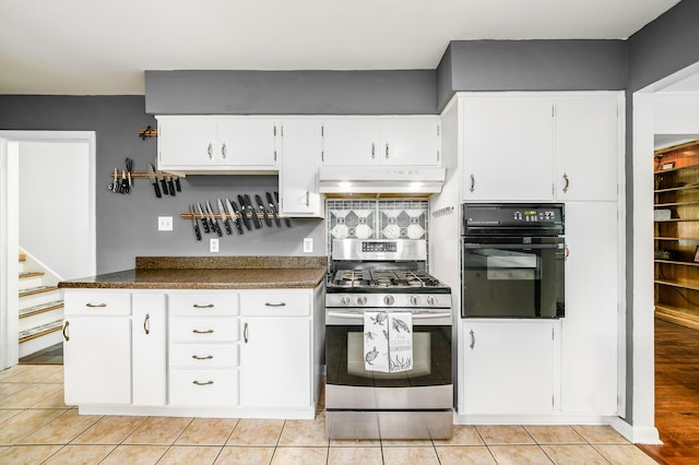2175 Ridgeview Rd, Upper Arlington, OH 43221 - kitchen with oven, stainless steel range with gas stovetop, under cabinet range hood, dark countertops, and white cabinets