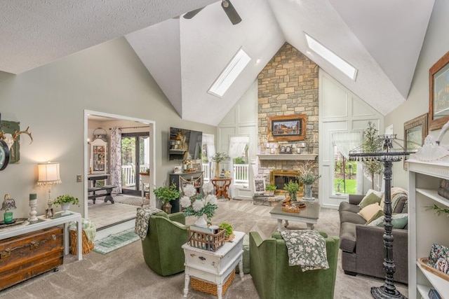 4561 Bent Creek Pl, Grove City, OH 43123 - carpeted living room featuring a skylight, a fireplace, ceiling fan, and high vaulted ceiling
