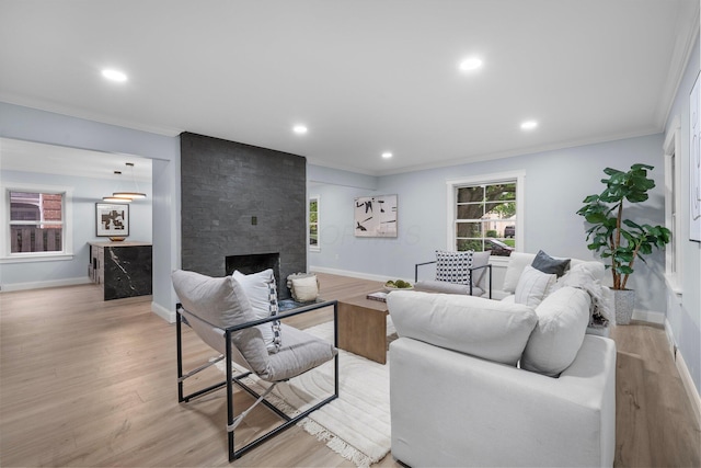2583 Wexford Rd, Columbus, OH 43221 - living room with crown molding, a stone fireplace, light wood finished floors, baseboards, and recessed lighting