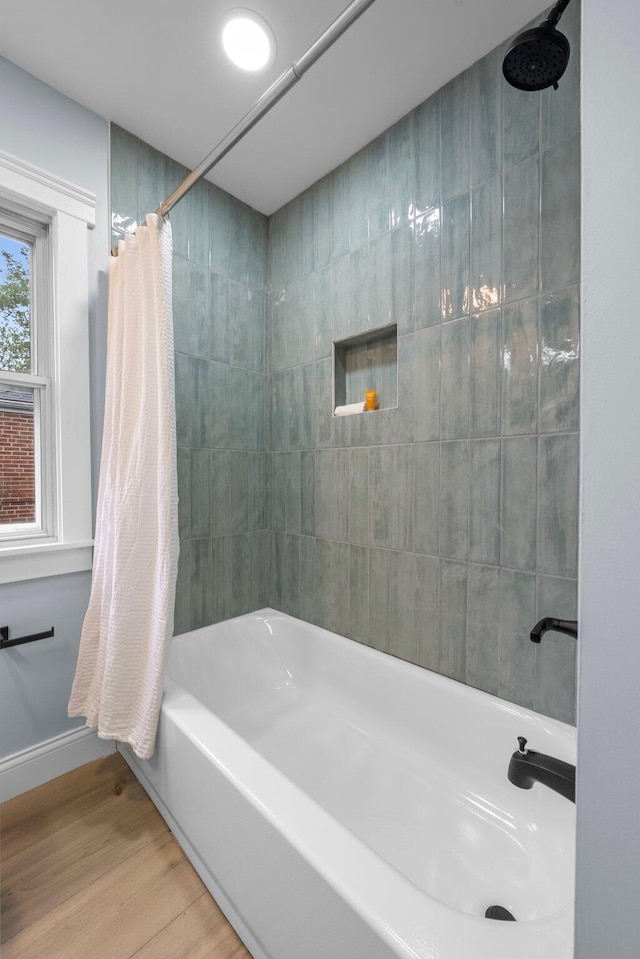 2583 Wexford Rd, Columbus, OH 43221 - full bathroom featuring shower / bathtub combination with curtain, wood finished floors, and baseboards
