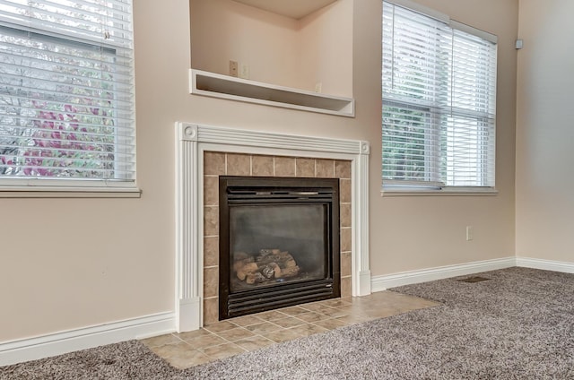 2697 Rinaldi Dr, Columbus, OH 43219 - detailed view of baseboards, a tile fireplace, and carpet flooring