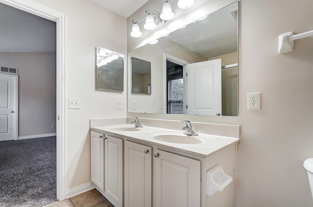 2697 Rinaldi Dr, Columbus, OH 43219 - full bath featuring double vanity, baseboards, and tile patterned floors