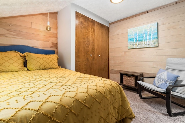 796 Mulberry Dr, Columbus, OH 43235 - carpeted bedroom with wooden walls, a closet, and a textured ceiling