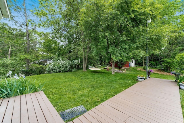 796 Mulberry Dr, Columbus, OH 43235 - view of green lawn featuring a wooden deck and view of wooded area