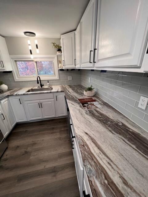 79 N Main St, Jeffersonville, OH 43128 - kitchen with white cabinetry, a sink, light stone counters, and decorative backsplash