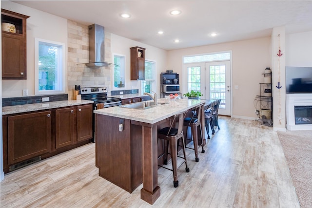 7326 State Route 19 Unit 9, Lot 297, Mount Gilead, OH 43338 - kitchen with wall chimney range hood, a sink, light wood-type flooring, stainless steel range with electric cooktop, and recessed lighting