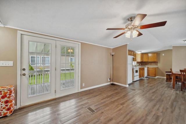 8 Winter Pine Dr, Delaware, OH 43015 - unfurnished living room featuring dark wood-type flooring, a ceiling fan, lofted ceiling, and ornamental molding