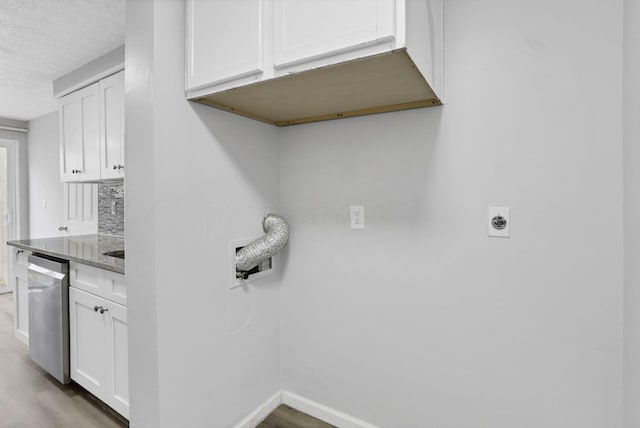2505 Burgandy Ln Unit C, Columbus, OH 43232 - laundry area featuring baseboards, electric dryer hookup, light wood-style floors, a textured ceiling, and cabinet space
