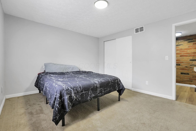 2505 Burgandy Ln Unit C, Columbus, OH 43232 - carpeted bedroom featuring baseboards, a textured ceiling, and a closet