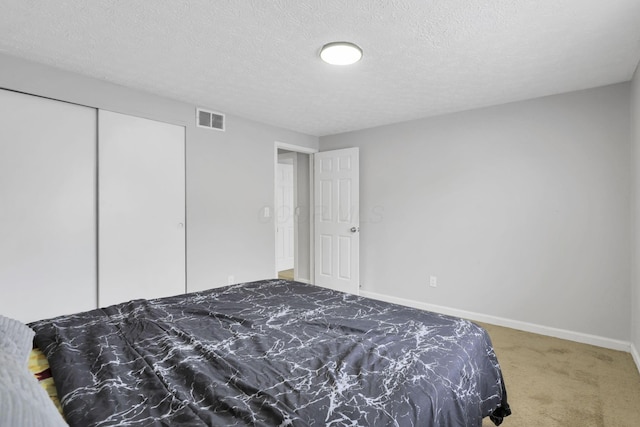 2505 Burgandy Ln Unit C, Columbus, OH 43232 - carpeted bedroom featuring baseboards, a textured ceiling, and a closet