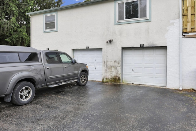 2505 Burgandy Ln Unit C, Columbus, OH 43232 - view of property exterior with stucco siding, a garage, and asphalt driveway