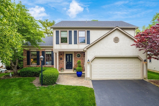 5584 Tangarey Ct, Columbus, OH 43235 - view of front facade with asphalt driveway, stucco siding, a front yard, and brick siding