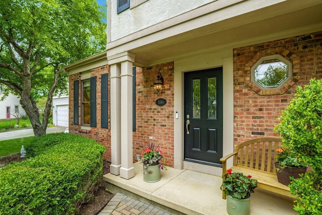 5584 Tangarey Ct, Columbus, OH 43235 - property entrance featuring brick siding, covered porch, and a garage