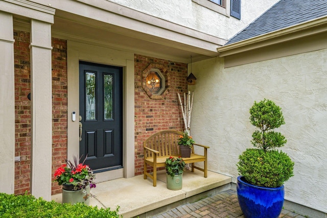 5584 Tangarey Ct, Columbus, OH 43235 - entrance to property with stucco siding, a shingled roof, covered porch, and brick siding