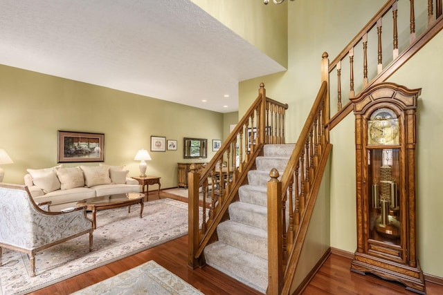 5584 Tangarey Ct, Columbus, OH 43235 - staircase with wood finished floors, recessed lighting, baseboards, and a towering ceiling