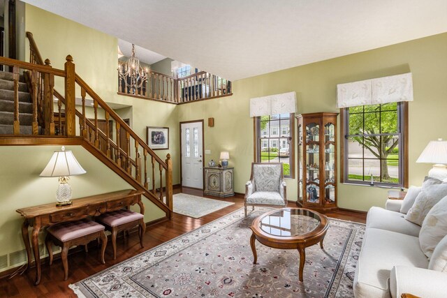 5584 Tangarey Ct, Columbus, OH 43235 - living room with a chandelier, stairs, wood finished floors, and baseboards