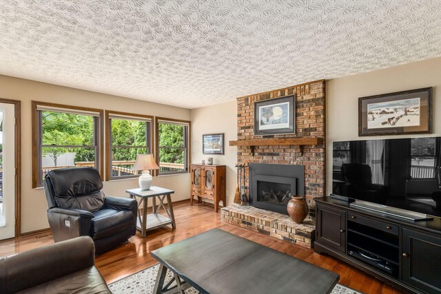 5584 Tangarey Ct, Columbus, OH 43235 - living area with a brick fireplace and wood finished floors