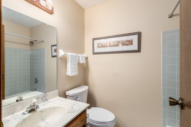 5584 Tangarey Ct, Columbus, OH 43235 - full bathroom with  shower combination, vanity, toilet, and a textured ceiling