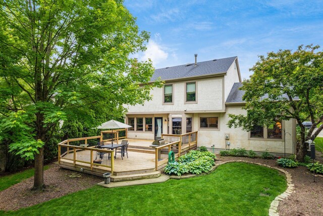 5584 Tangarey Ct, Columbus, OH 43235 - back of house featuring stucco siding, a shingled roof, a lawn, and a wooden deck