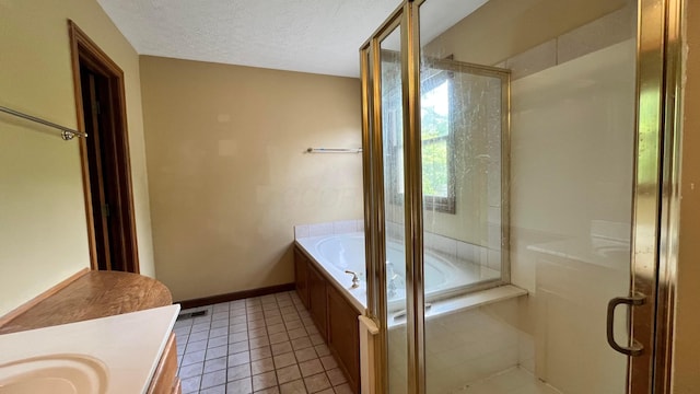 5459 Red Wynne Ln, Hilliard, OH 43026 - bathroom featuring vanity, a shower stall, a garden tub, baseboards, and a textured ceiling