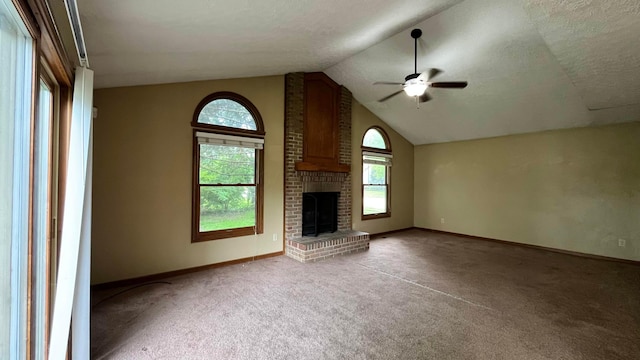 5459 Red Wynne Ln, Hilliard, OH 43026 - unfurnished living room with ceiling fan, light carpet, vaulted ceiling, a brick fireplace, and baseboards