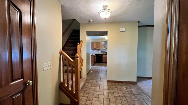 5459 Red Wynne Ln, Hilliard, OH 43026 - entrance foyer with stone tile flooring, a textured ceiling, baseboards, and stairs