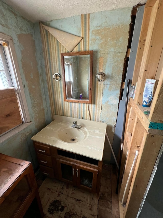527 N 15th St, Coshocton, OH 43812 - bathroom with wallpapered walls, vanity, and a textured ceiling