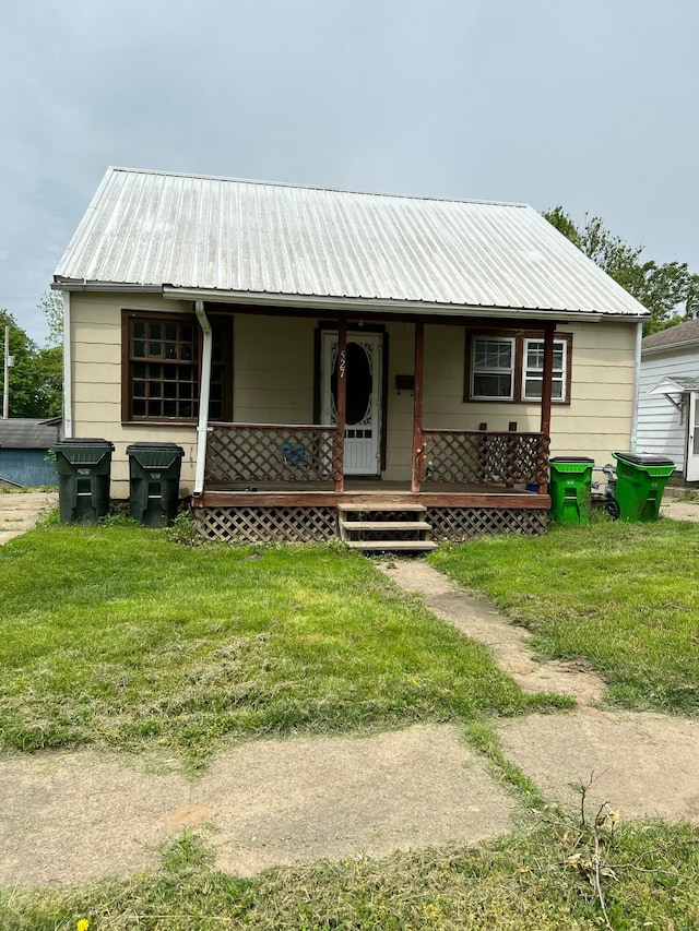 527 N 15th St, Coshocton, OH 43812 - view of front of property with covered porch, metal roof, and a front lawn