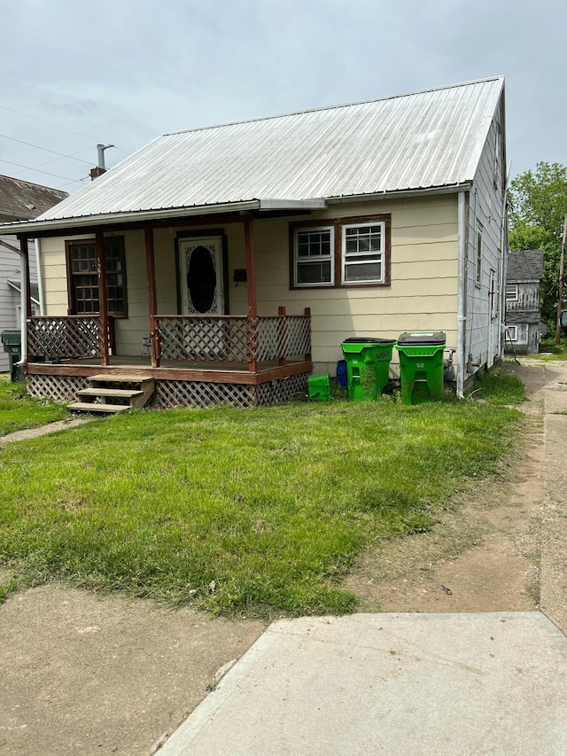 527 N 15th St, Coshocton, OH 43812 - view of front of home with a front yard, metal roof, and covered porch