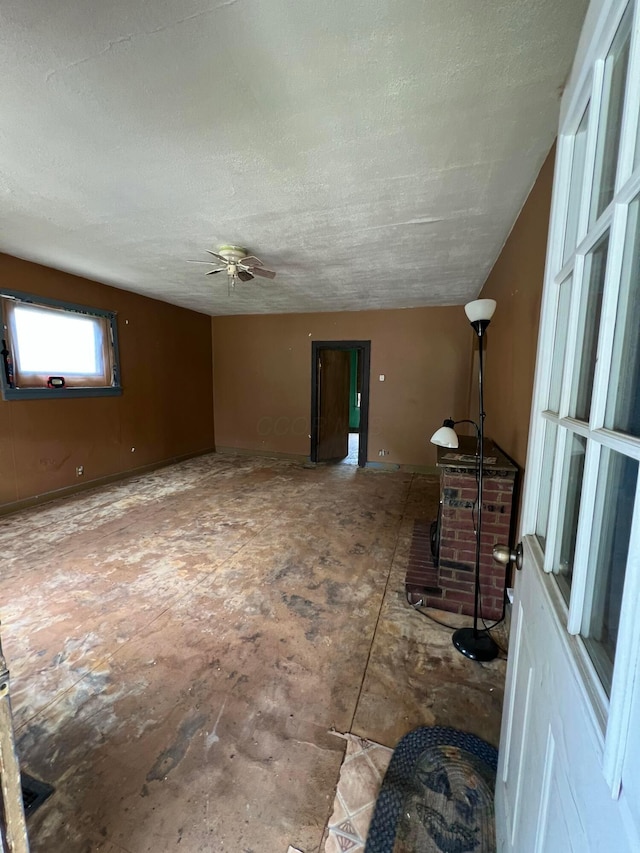 527 N 15th St, Coshocton, OH 43812 - unfurnished living room featuring a textured ceiling and ceiling fan