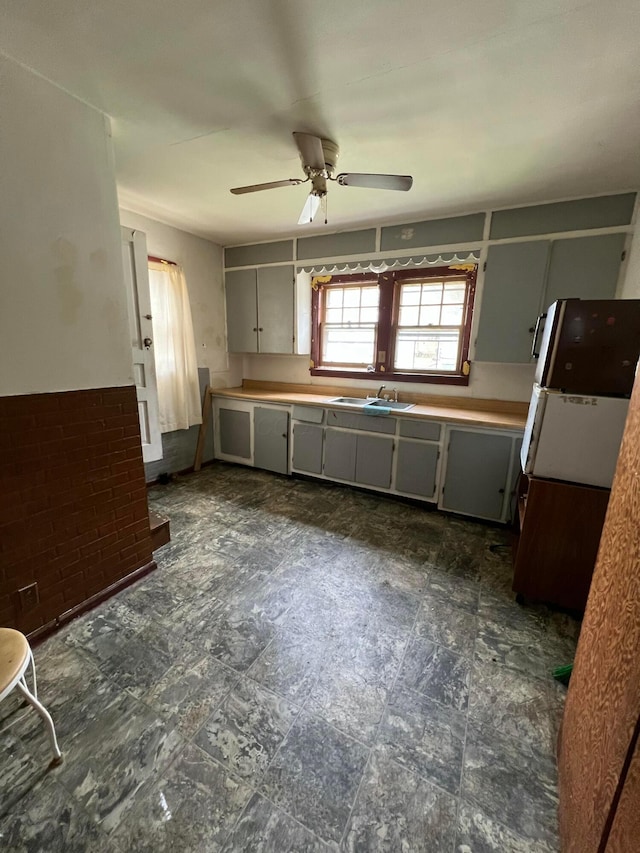 527 N 15th St, Coshocton, OH 43812 - kitchen with gray cabinets, a sink, a ceiling fan, and light countertops