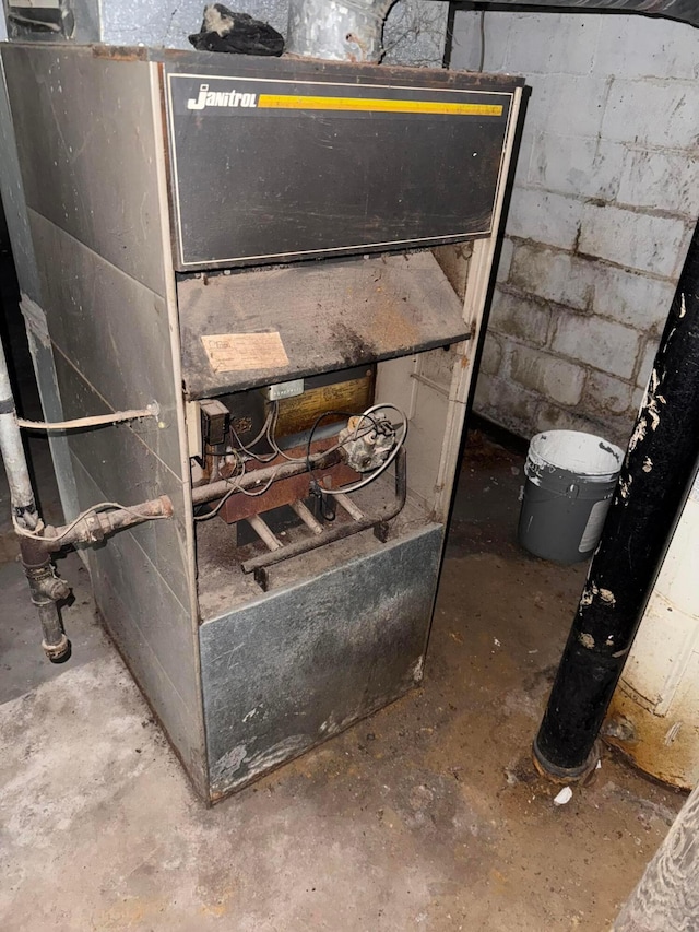 527 N 15th St, Coshocton, OH 43812 - basement view of concrete block wall, unfinished concrete flooring, and heating unit