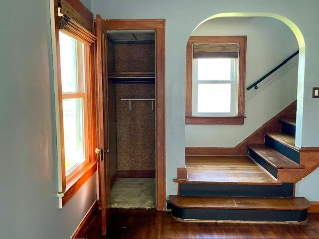 221 S Sylvan Ave, Columbus, OH 43204 - stairway with wood finished floors, baseboards, and arched walkways