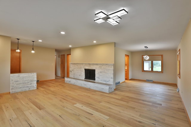 465 W Schrock Rd, Westerville, OH 43081 - unfurnished living room with baseboards, light wood-type flooring, recessed lighting, and a fireplace