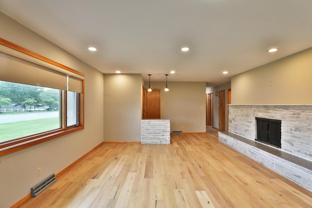 465 W Schrock Rd, Westerville, OH 43081 - unfurnished living room featuring baseboards, recessed lighting, light wood-style floors, and a fireplace with raised hearth