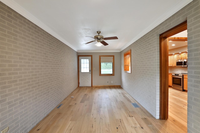 465 W Schrock Rd, Westerville, OH 43081 - unfurnished room with ornamental molding, a ceiling fan, light wood-style flooring, brick wall, and baseboards