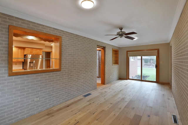 465 W Schrock Rd, Westerville, OH 43081 - empty room with a ceiling fan, ornamental molding, light wood-style flooring, baseboards, and brick wall
