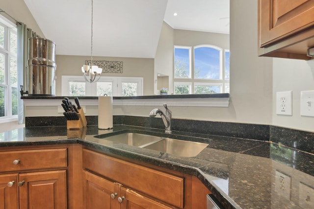8708 Belworth Sq, New Albany, OH 43054 - kitchen with a sink, brown cabinets, plenty of natural light, dark countertops, and vaulted ceiling