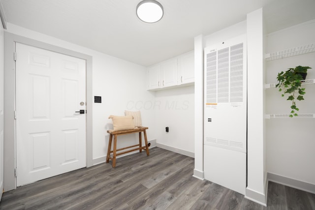 25 Vernon Ave, London, OH 43140 - laundry room with a heating unit, dark wood-type flooring, and baseboards