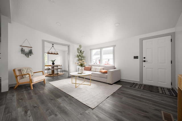 25 Vernon Ave, London, OH 43140 - living area featuring vaulted ceiling, dark wood-style floors, a chandelier, and baseboards