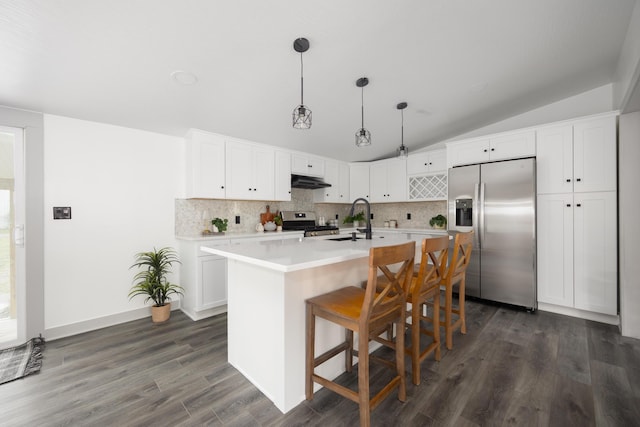 25 Vernon Ave, London, OH 43140 - kitchen featuring stainless steel appliances, under cabinet range hood, a sink, vaulted ceiling, and tasteful backsplash