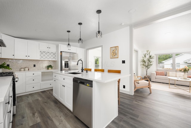 25 Vernon Ave, London, OH 43140 - kitchen featuring appliances with stainless steel finishes, light countertops, tasteful backsplash, a sink, and dark wood finished floors