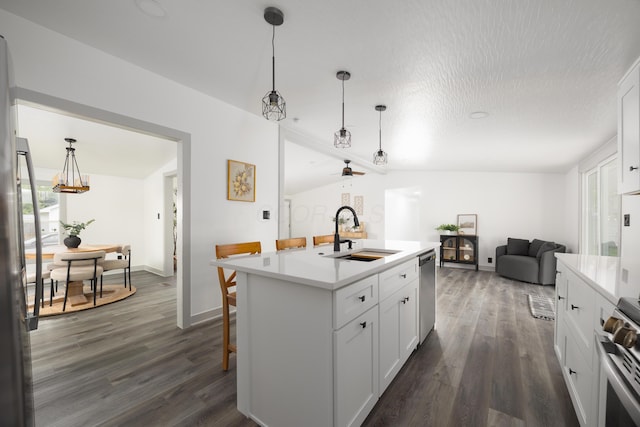 25 Vernon Ave, London, OH 43140 - kitchen featuring a sink, appliances with stainless steel finishes, open floor plan, light countertops, and dark wood-type flooring