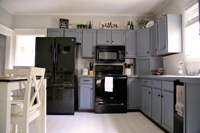 632 E 5th Ave, Lancaster, OH 43130 - kitchen with black appliances, gray cabinets, light flooring, crown molding, and light countertops