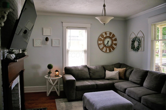 632 E 5th Ave, Lancaster, OH 43130 - living room with a brick fireplace, wood finished floors, a textured ceiling, crown molding, and baseboards