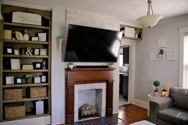 632 E 5th Ave, Lancaster, OH 43130 - living room with wood finished floors, ornamental molding, a textured ceiling, and a fireplace