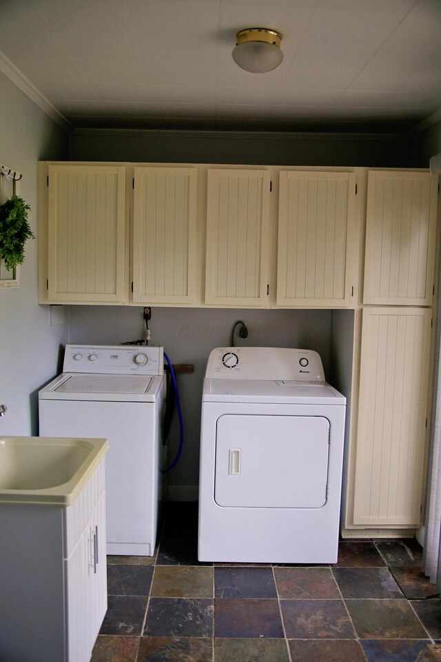 632 E 5th Ave, Lancaster, OH 43130 - laundry area with cabinet space, separate washer and dryer, ornamental molding, and stone tile flooring