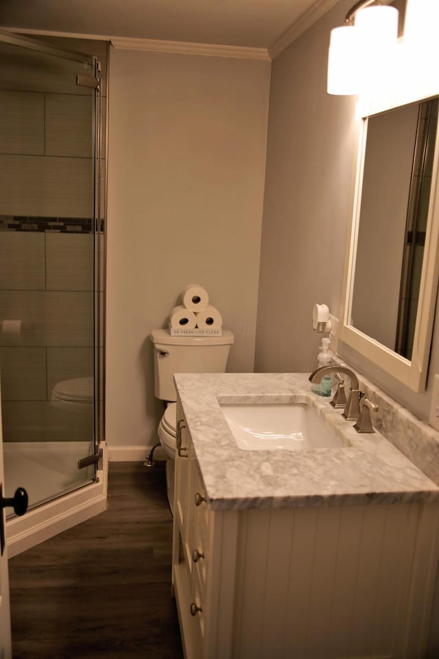 632 E 5th Ave, Lancaster, OH 43130 - full bathroom featuring toilet, vanity, a stall shower, wood finished floors, and ornamental molding